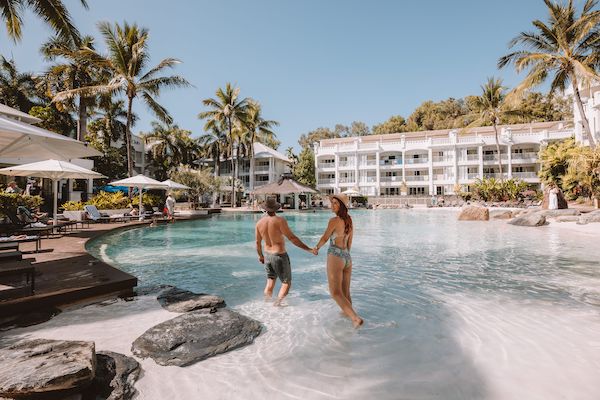 Couple enjoying the pool setting at Peppers Beach Club Palm Cove