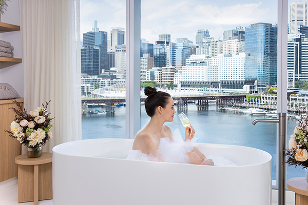 Woman soaking in bath at Sofitel Spa Darling Harbour