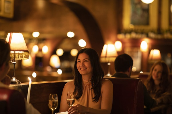  Couple enjoying food and drink at French restaurant Restaurant Hubert, Sydney
