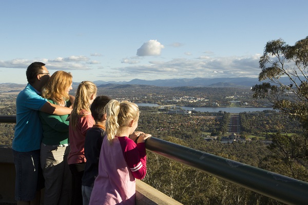 A family enjoying the view of Canberra from Mt Ainslie
