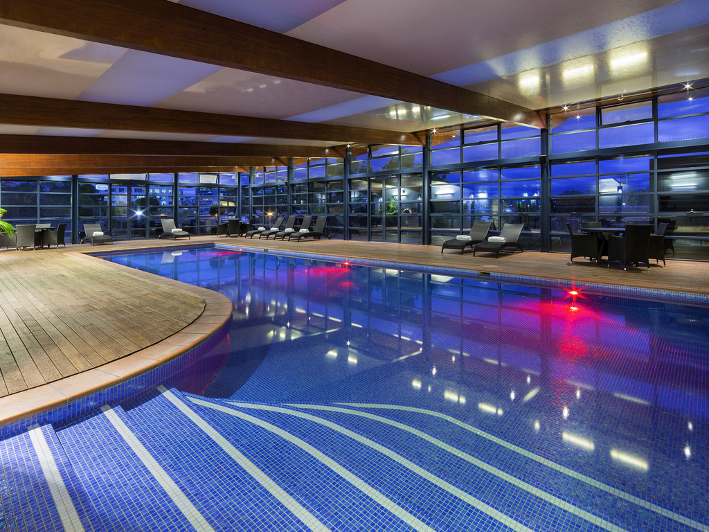 Pool area lit up at night at Novotel Canberra