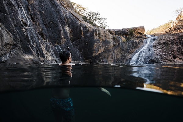 A person swimming at Serpentine Falls
