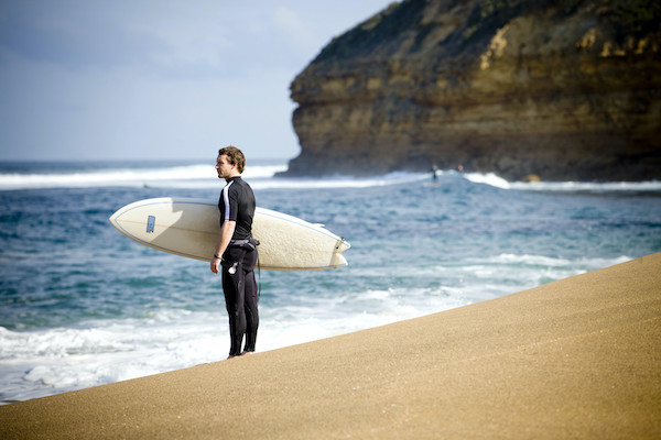 Surfer looking at the swell on Bells Beach, Victoria 